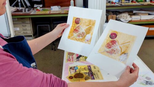 Artist holding completed Monoprints